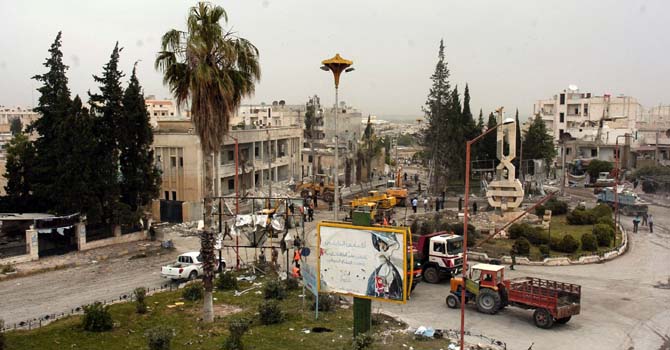 A general view of the site where two bombs detonated near state buildings in the northern city of Idlib