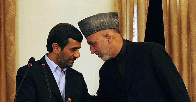 Afghan President Karzai talks with Iranian counterpart Ahmadinejad during a news conference in Kabul