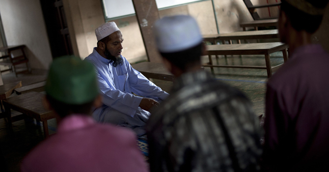 An-ethnic-Rohingya-refugee-teacher-recites-holy-verses-for-students-inside-their-community-school-in-Klang670 An ethnic Rohingya refugee teacher recites holy verses for students inside their community school in Klang.—AFP Photo