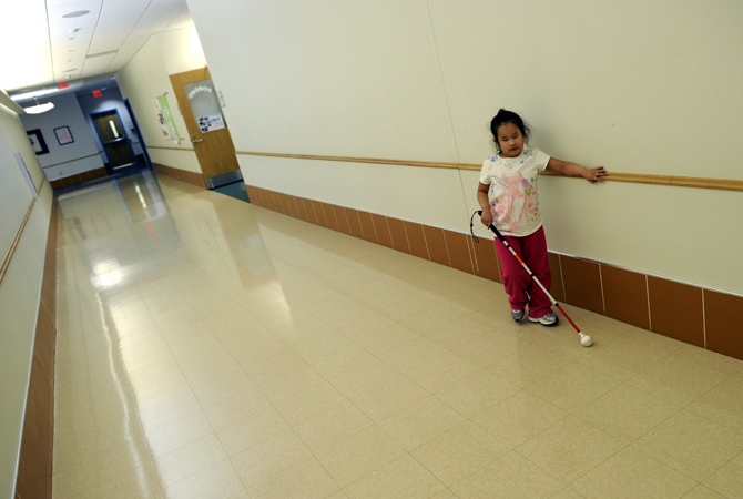 Maria Merano walks down the hall at the Concordia Learning Center at St. Joseph's School for the Blind in Jersey Cit , New Jersey.