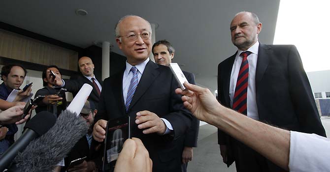 Director General of the International Atomic Energy Agency, IAEA, Yukiya Amano from Japan and Herman Nackaerts, from left, of the IAEA the chief agency official in charge of the Iran file speak to the media before his flight to Iran at the Vienna International Airport near Schwechat, Austria, on Sunday, May 20, 2012. (AP Photo/Ronald Zak)