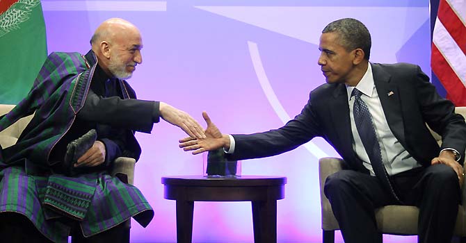 President Barack Obama, right, shakes hands with with Afghan President Hamid Karzai, left, during their meeting at the NATO Summit in Chicago, Sunday, May 20, 2012. Karzai thanked Americans for the help their 'taxpayer money' has done in Afghanistan. (AP Photo/Pablo Martinez Monsivais)
