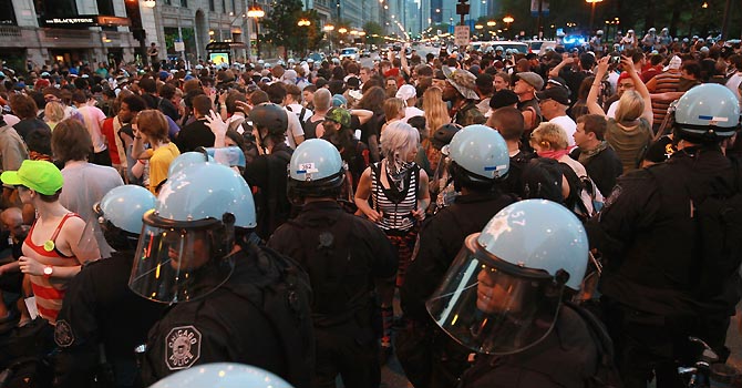 Demonstrators confront police on Michigan Avenue as they march through the downtown streets on May 19, 2012 in Chicago, Illinois. This was the sixth day of protests in front of the NATO Summit which runs May 20-21.   Scott Olson/Getty Images/AFP== FOR NEWSPAPERS, INTERNET, TELCOS & TELEVISION USE ONLY ==