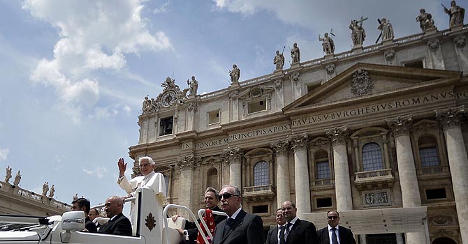 VATICAN-RELIGION Pope Benedict XVI leaves on the Popemobile surrounded by Vatican gendarmes after his audience to the group renewal in the spirit in Saint Peter's Square at the Vatican on May 26, 2012. Vatican police arrested a man the day before, reportedly the pope's butler, on allegations of having leaked confidential documents and letters from the pontiff's private study to newspapers. The man was caught in possession of secret documents, the Vatican said, but it would not confirm the suspect's identity, age, or when he had been arrested. AFP PHOTO/ FILIPPO MONTEFORTE
