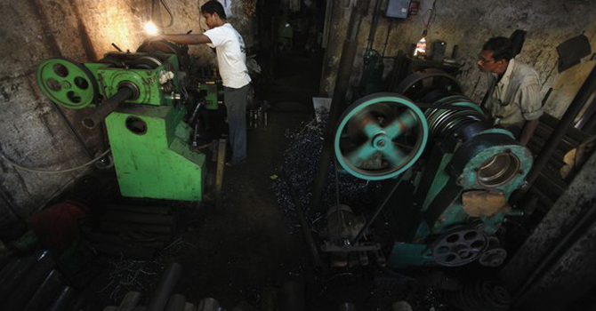 workers-make-spare-parts-for-a-drilling-machine-in-Kolkata670 Workers make spare parts for a drilling machine inside a factory in Kolkata, India.—Reuters Photo