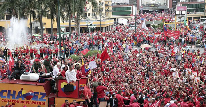 Venezuela's President Hugo Chavez waves to supporters before the registration of his presidential bid to the electoral authorities. – Reuters 