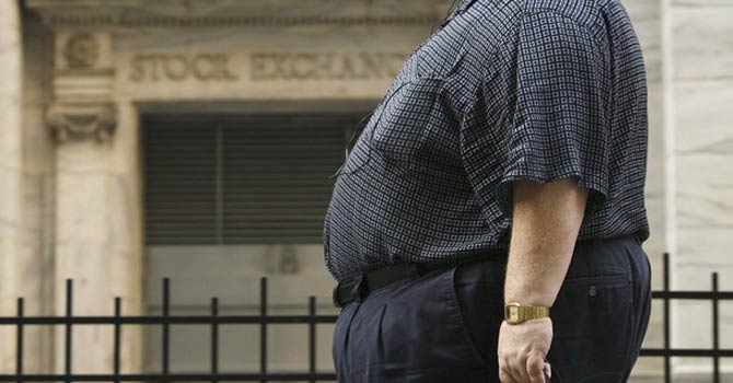 An obese woman walks along the boardwalk while leaving the U.S. Open tennis tournament in New York. – Reuters