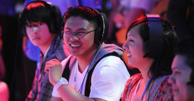 Attendees play video games during the Electronic Entertainment Expo (E3). – Reuters 
