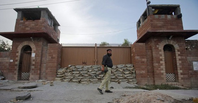  A police officer walks past Central Jail in Peshawar.—Reuters Photo