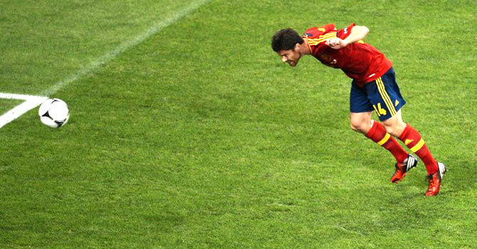 Spain's Xabi Alonso heads his side into the lead against France in their Euro 2012 quarter-final - Photo by AFP