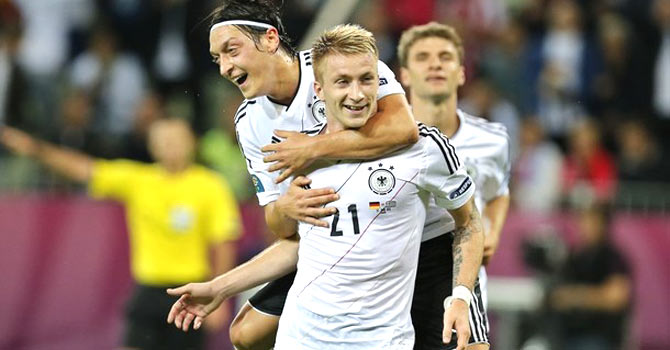 Germany's Marco Reus and Mesut Oezil celebrate their team's fourth goal against Greece. - Photo by AP
