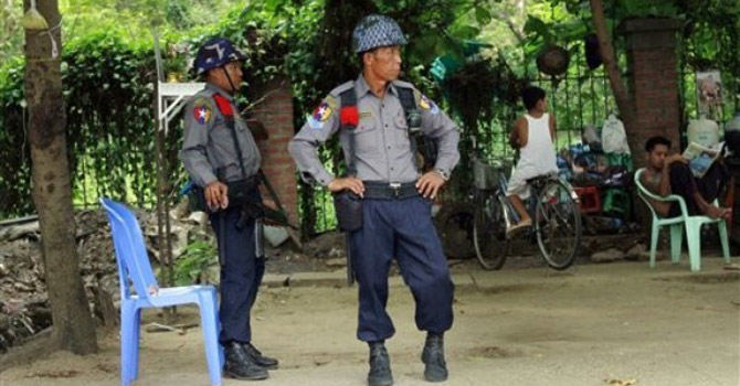 Myanmar police officers stand guard.—AP Photo