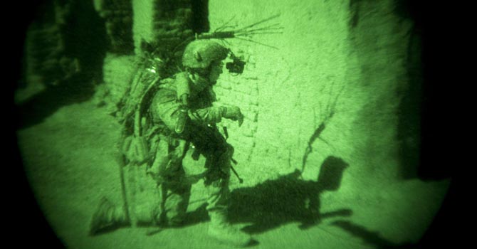 A U.S. Army soldier of 82nd Airborne Division guards an entrance of Afghan National Police compound during a patrol in the town of Senjaray, Zahri district of Kandahar province, southern Afghanistan