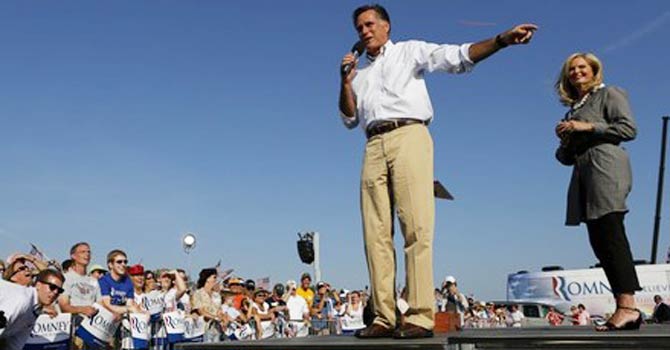 U.S. Republican presidential candidate Mitt Romney and his wife Ann, address a crowd during a campaign event at Holland State Park in Michigan - Reuters