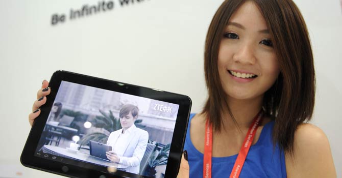 A promoter displays the 'tough pad' during the CommunicAsia telecom expo and conference - AFP