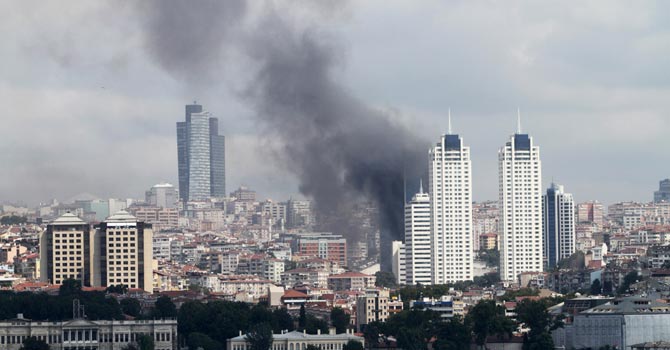 Dark clouds of smoke billowing over the Besiktas district of Istanbul, after a fire broke out at a 42-storey building.—AFP Photo