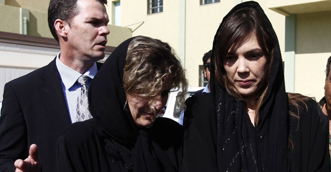 International Criminal Court (ICC) lawyer Melinda Taylor (R) and her Lebanese translator walk after being released by a Zintan brigade that detained them for three weeks ago in Zintan July 2, 2012. Libya freed four officials from the ICC on Monday, whose detention since early June on spying allegations had plunged the interim government into its biggest diplomatic controversy since last year's revolution. REUTERS/Anis Mili (LIBYA - Tags: CIVIL UNREST CRIME LAW POLITICS)