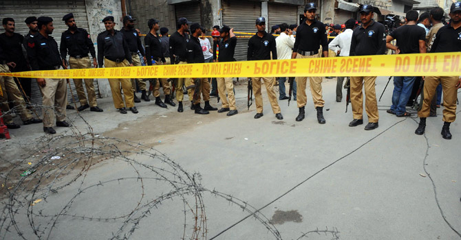 Pakistani policemen seal off the area of an attack.—AFP Photo