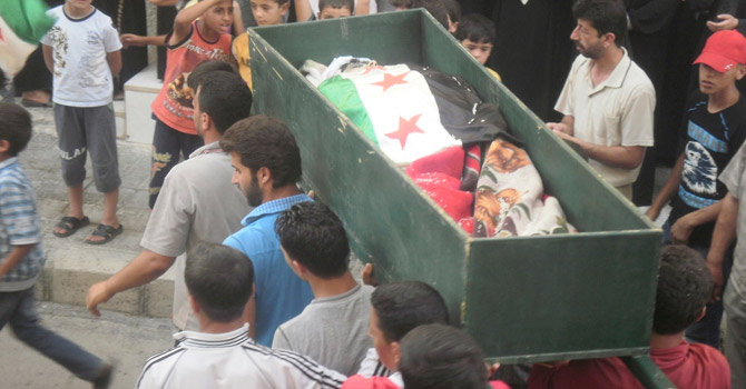 Residents carry the coffin of a Syrian who was killed by Syrian forces.—Reuters Photo