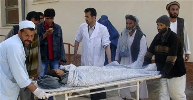 Afghans transport a boy injured in a bomb blast. — AP Photo