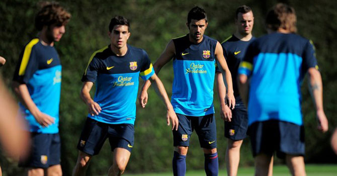 FC Barcelona's David Villa, third right, attends the first training session of the 2012-2013 football season at the Sports Center FC Bacelona Joan Gamper in the San Joan Despi, Spain, Tuesday, July 17, 2012. (AP Photo