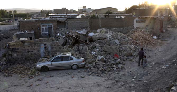 Mideast Iran Earthquake Ruins of a houses are seen after an earthquake in the city of Varzaqan in northwestern Iran, on Saturday, Aug. 11, 2012. A 6.2-magnitude earthquake hit the towns of Ahar, Haris and Varzaqan in East Azerbaijan province in northwestern Iran on Saturday, state TV said. Iran is located on seismic fault lines and is prone to earthquakes. It experiences at least one earthquake every day on average, although the vast majority are so small they go unnoticed. (AP Photo/Mehr News Agency, Hamed Nazari)