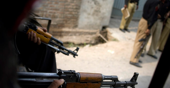 Police officers hold their weapons as they stand guard in Peshawar. – File photo by AP