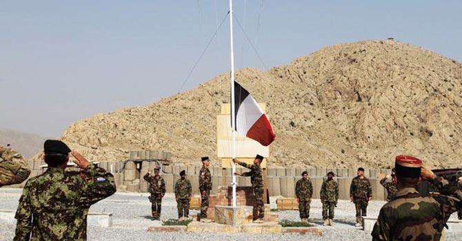 The French national flag is lowered during a transfer of authority ceremony from the Nato forces to Afghan security forces. — AP Photo