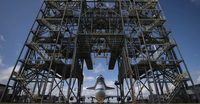 A NASA handout of Space shuttle Endeavour, mated atop NASA's Shuttle Carrier Aircraft, is moved back into the Shuttle Mate-Demate Device at the Kennedy Space Center, Shuttle Landing Facility in Cape Canaveral
