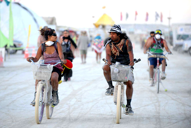 Burners ride their bicycle through the streets of Burning Man near Gerlach, Nev. on Aug. 28, 2012.