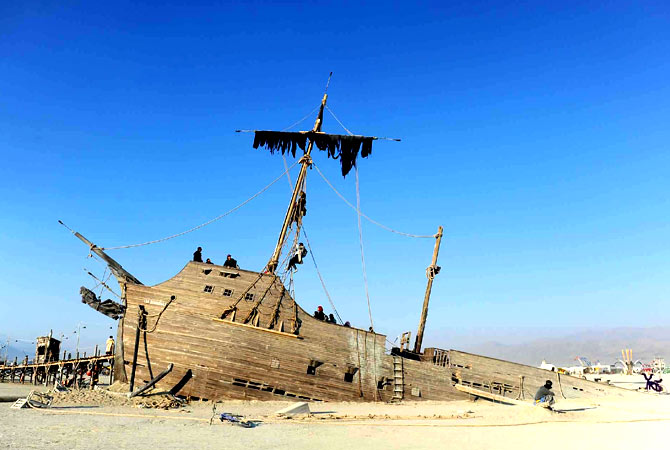 An art piece named La Llorona rests on the playa.