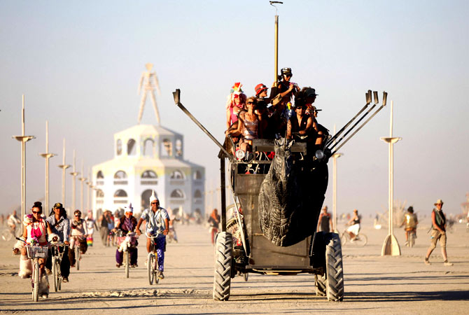 Participants ride an art car.