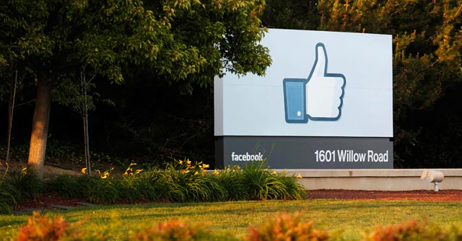The sun sets on the entrance sign at Facebook's headquarters in Menlo Park, California – File photo by Reuters