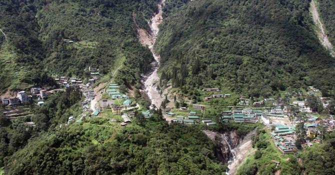 The Indian Mongon – Chungthang road is seen destroyed by a landslide, some 30 kms north of the Gangtok the capital of Sikkim on September 24, 2012.  Flash floods and landslides triggered by heavy monsoon rains in northeast India have claimed at least 26 lives and another eight people are missing, a report said. India's army and air force launched rescue operations in areas badly hit by the rains that have been lashing the states of Sikkim, Assam and Arunachal Pradesh for days, the Press Trust of India said. AFP PHOTO/ STR