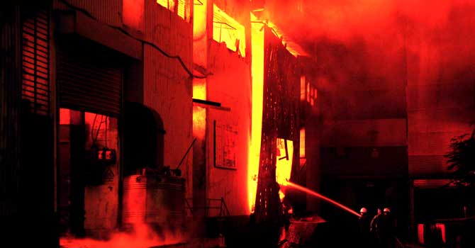 karachi-factory-fire-670 Fire-fighters try to control the blaze at Karachi's garment factory on September 11, 2012. - Photo by AFP
