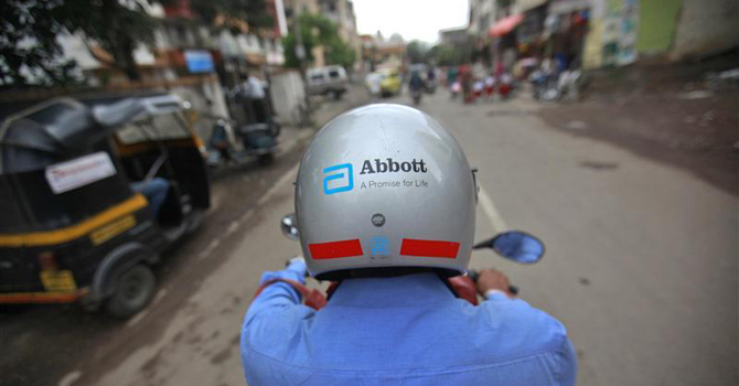 A representative for Abbott rides his bike to a doctor's clinic in Pune
