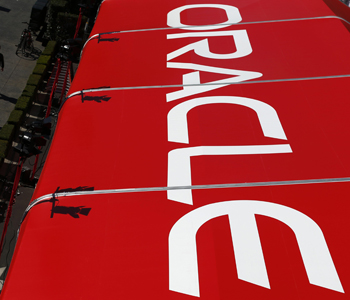Pedestrians walk past an Oracle tent during OpenWorld 2012 in San Francisco