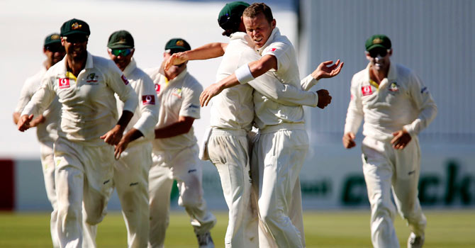 Nathan Lyon congratulates Peter Siddle (centre R) for taking the wicket of South Africa's Dale Steyn during the fifth day's play of the second cricket test match at the Adelaide cricket ground. Siddle's late burst was unable to hand Australia a win in a thrilling end to the second Test. – Photo by Reuters