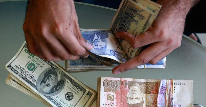 A foreign exchange dealer in Karachi. – File photo by Reuters
