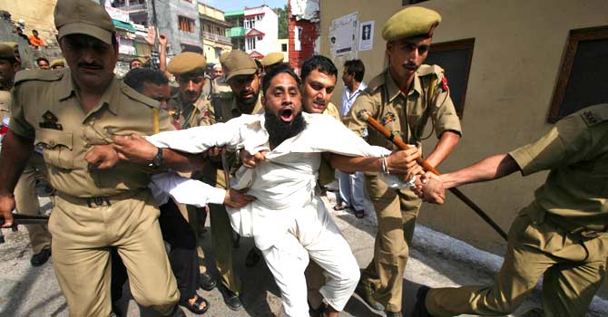 Police detain a demonstrator as he shouts slogans during a protest. – File photo by Reuters