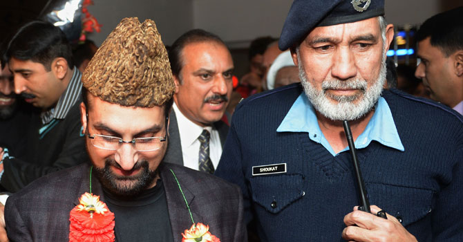 Leader of the moderate All Parties Hurriyat Conference Mirwaiz Umar Farooq (L) comes out from airport upon his arrival in Islamabad on December 15, 2012. - Photo by AFP