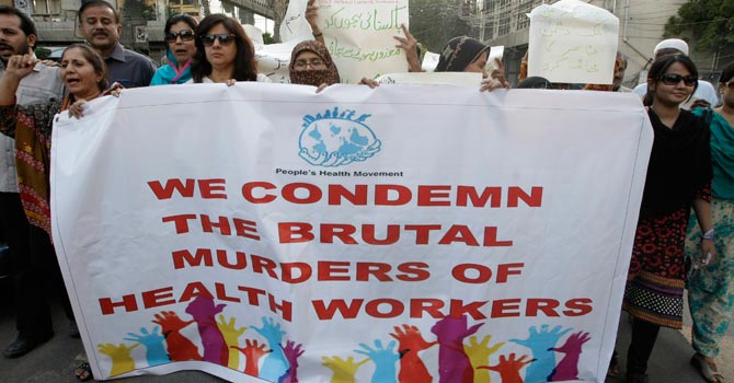 Activists rally in Karachi to condemn killings of health workers. -AP Photo