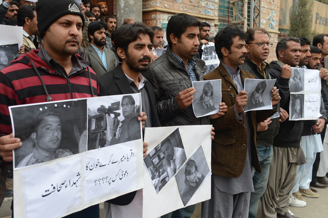 Pakistani media representatives hold pictures of killed journalists during a protest in Quetta on January 11, 2013, against the bomb attacks. – Photo by AFP