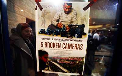 A poster for the Oscar-nominated documentary '5 Broken Cameras' is displayed at a theatre in the West Bank city of Ramallah. —Photo by Reuters