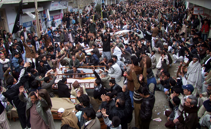 People chant slogans next to the bodies of their relatives awaiting burial, who were killed in Thursday's deadly bombings, at a protest rally on Friday, January 11, 2013 in Quetta. – Photo by AP