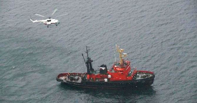 A handout photo provided on Jan 28, 2013 by the Russian Emergencies Ministry's Far East Regional Centre and taken from a flying aircraft shows a rescuers helicopter and ship taking part in the search operation for the missing crew members from a Russian fishing vessel that capsized in the Sea of Japan. The Chance-101 fishing boat had 30 crew members on board (19 Russians and 11 Indonesians) when it sank yesterday. Six people were found dead, 15 rescued yesterday, the Russian media reported quoting officials as saying. - AFP Photo