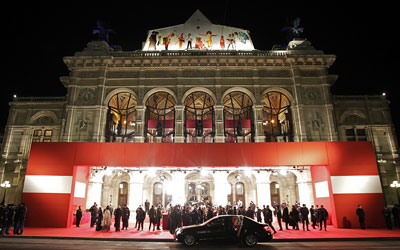 Spectators watch the arrivals of guests at the traditional Opera Ball in front of the state opera house in Vienna last year. —Photo by Reuters