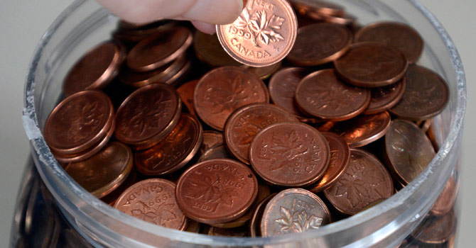 The household penny jar seen here Monday, Feb. 4, 2013, in Montreal, may soon become a thing of the past. The phasing-out of the penny will begin Feb. 4, 2013 with the Royal Canadian Mint officially ending its distribution of one-cent coins to Canada's financial institutions. Retailers will round consumer cash transactions to the nearest nickel. - AP Photo