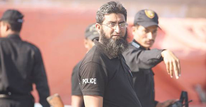 The law enforcers regarding this photographer with some suspicion.