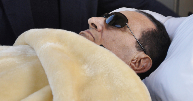 Former Egyptian President Hosni Mubarak is wheeled into court in Cairo. —Photo by AP